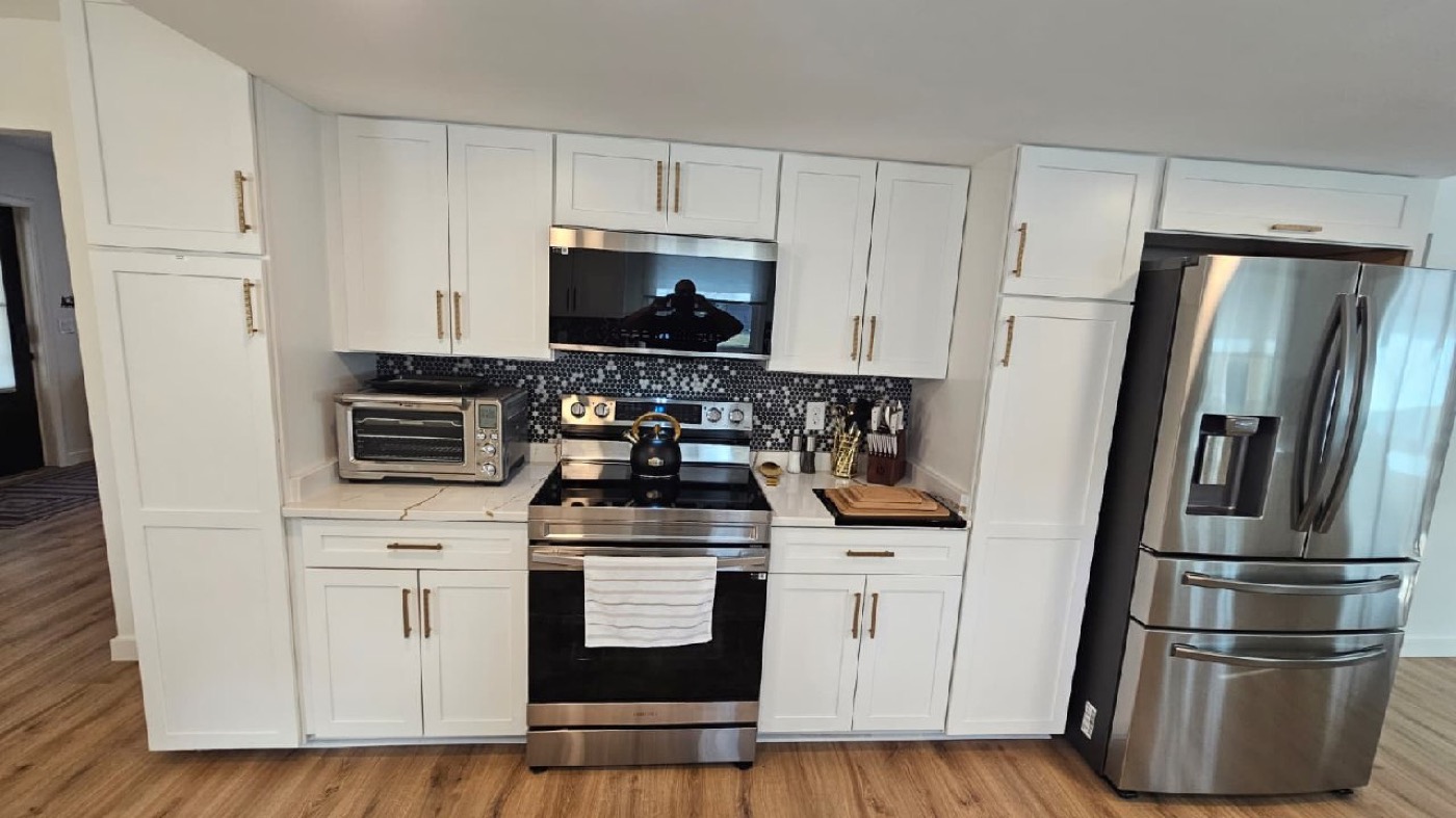 Stainless range, microwave, and 4-door French door refrigerator